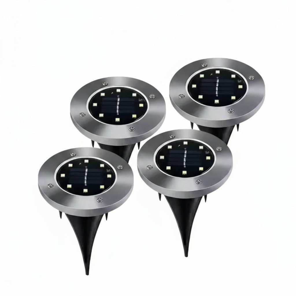 Set of four solar-powered outdoor lights with LED lights on a white background.