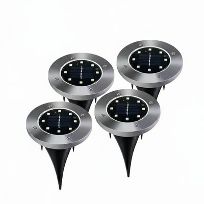 Set of four solar-powered outdoor lights with LED lights on a white background.